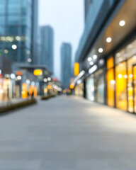 Urban shopping district at dusk with blurred storefronts and city lights illuminating the pathway