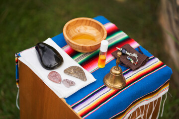 Massage therapist preparing natural oils and stones for relaxing treatment