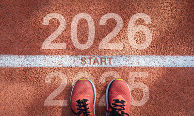 New year 2026 concept, beginning of success. Text 2026 written on asphalt road and male runner...