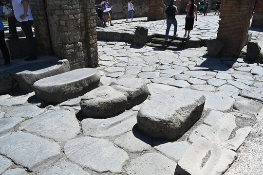Ancient stepping stones to allow pedestrians to cross roads from the the raised sidewalks . Pompeii, Italy 