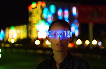 Asian woman in Futuristic High-tech VR Eyewear in night city. Ar