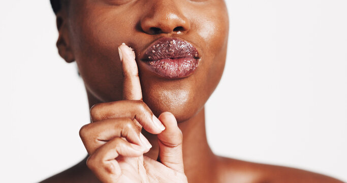 Beauty, lip scrub and cosmetics with black woman in studio for exfoliation, spa treatment and skincare. Sugar, facial and dermatology with closeup of person on white background for self care