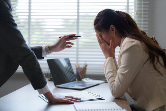 Manager scolding employee for bad work results in office meeting