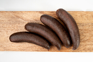 Black pudding isolated, blood sausage kaszanka, traditional Polish terrine, brawn sausages on white