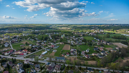 Aerial View of a Rural Landscape with Houses and Dense Forest in Poland