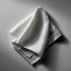 Elegant white napkin folded gracefully on a smooth surface, perfect for dining settings.