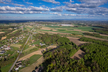 Aerial View of a Rural Landscape with Houses, Fields, and a Connecting Road in Poland