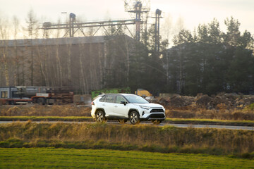 Fototapeta premium Hybrid vehicle moving along urban street