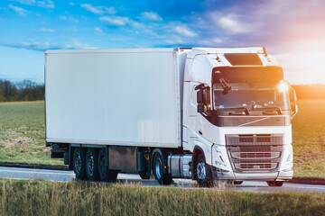 White delivery truck driving near fields