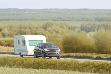 SUV pulling a caravan in nature