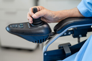 Fototapeta premium Asian senior woman patient on electric wheelchair with remote control at hospital, healthy strong medical.