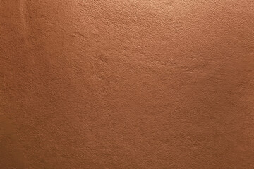 interior concrete wall, dark bronze brown orange shade, old grunge texture, tropical grainy sand surface