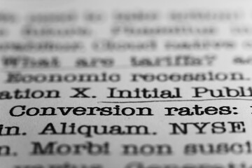 Conversion rates.. Text printed on a page. A piece of paper with a phrase written in retro...