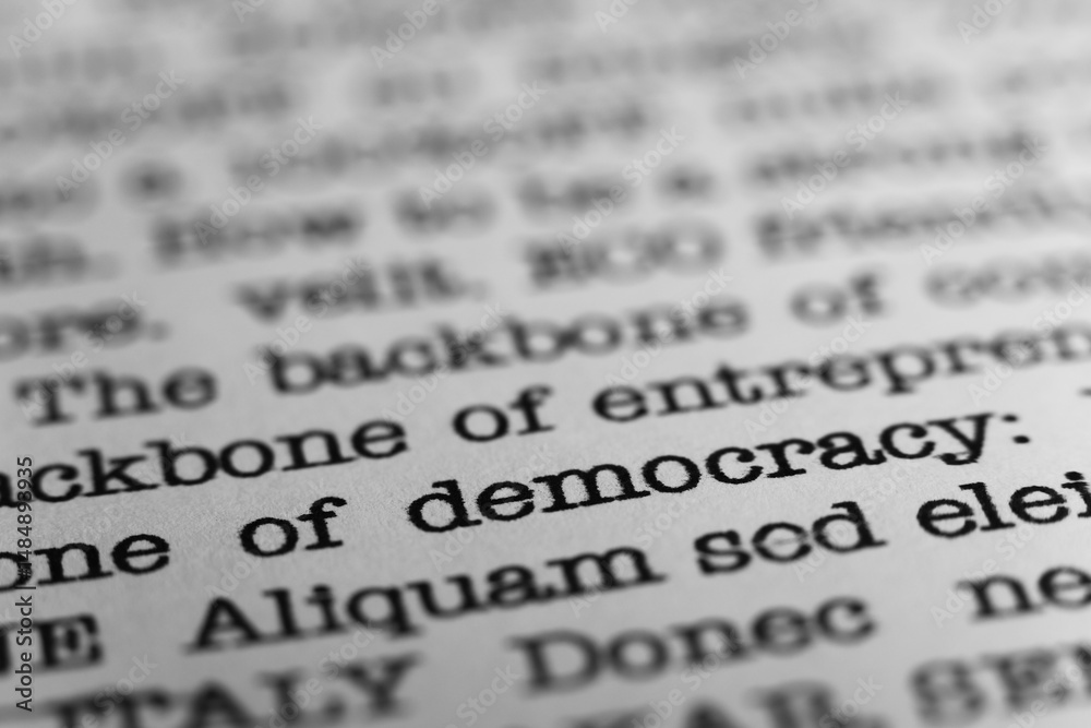 Fototapete democracy. political text printed on a page. a piece of paper with a phrase written in retro typewri