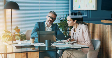Paperwork, laptop and business people in office with discussion for company investment deal. Computer, documents and finance manager with investor client for meeting with dividend report in workplace