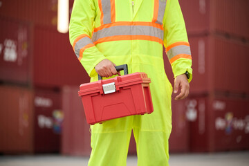 Technician or engineer holding tool box for fixing in warehouse storage