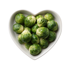 Fresh green brussels sprouts are presented in a heart shaped bowl on a white background, representing a healthy lifestyle concept and delicious ingredient for vegetarian or vegan diet cooking.