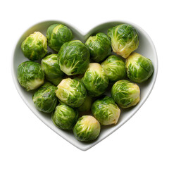 Fresh green brussels sprouts are presented in a heart shaped bowl on a white background, representing a healthy lifestyle concept and delicious ingredient for vegetarian or vegan diet cooking.
