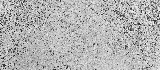 Dirty gray concrete wall with gravel stones texture background. Old rough and grunge texture wall. Texture of cement wall.