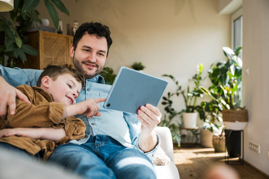Father and son enjoying quality time with a tablet indoors