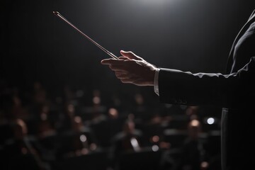 Fototapeta premium Orchestral conductor leading performance in concert hall
