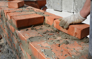 Mason bricklaying house brick wall close up