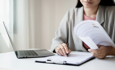 Business woman employer holding resume hiring recruit looking cv resume to hire candidates, analyzing information before job interview. Recruitment concepts