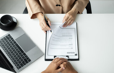 Business people hold a resume and talk to job applicants for job interviews about careers and Their personal history in the company. Recruitment concepts