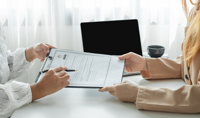 Business people hold a resume and talk to job applicants for job interviews about careers and Their personal history in the company. Recruitment concepts