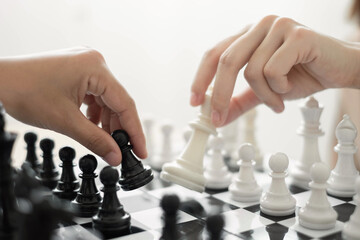 hand of businessmen moving chess in competition shows leadership, followers and business success strategies
