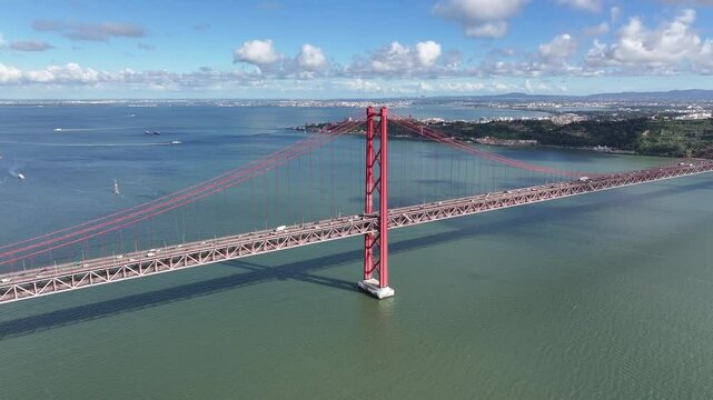 25Th April Bridge At Lisbon In Lisbon District Portugal. Megalopolis Downtown Cityscape. Vehicles Travel. 25Th April Bridge At Lisbon In Lisbon District Portugal. Cable Bridge Scenery.