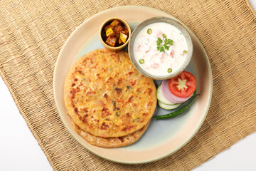 Indian traditional breakfast food aloo paratha is a potato  flatbread served with curd