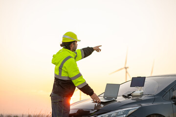 Engineer wearing uniform inspection and survey work in wind turbine farms rotation to generate...