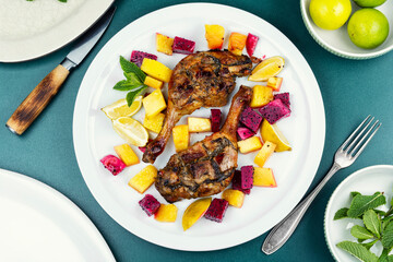 Duck roast with baked exotic fruits.