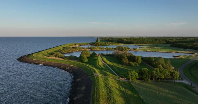 Flood barrrier, dike, water and nature, The Netherlands. waterline. artificial man made water works, The Netherlands.