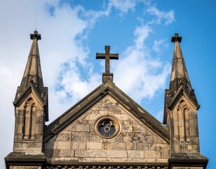The pointed twin spires and central cross of a gothic stone church reach into the heavens, steeped in history and solemn grandeur