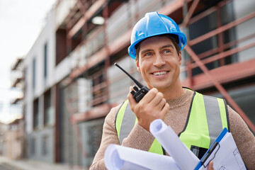 Engineer using walkie talkie at construction site
