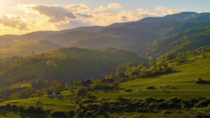 Aerial view of fields and landscape in the Pieniny Mountains in Poland during a May sunset,...
