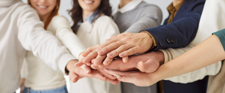 Friends team, corporate group office winners join hands to give high five together close up, success gesture, startup triumph, victory, teambuilding to increase motivation and promote cooperation