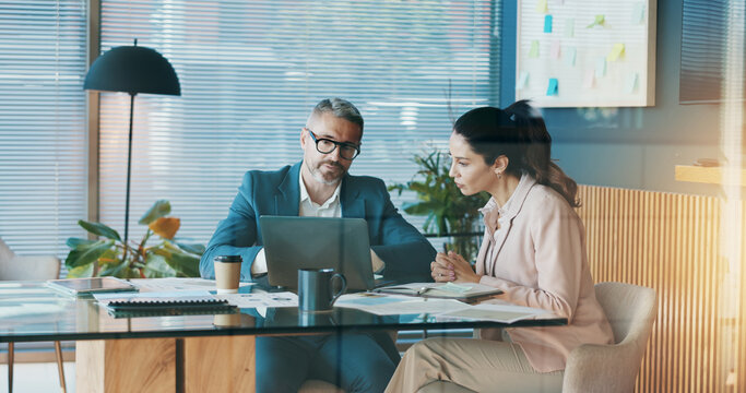 Documents, laptop and business people in office with discussion for company investment deal. Computer, paperwork and finance manager with investor client for meeting with dividend report in workplace