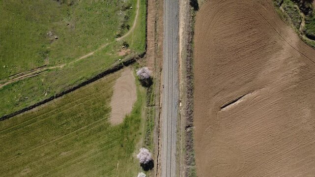 Aerial view of train tracks crossing the countryside