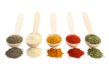 Different aromatic spices in wooden spoons isolated on white