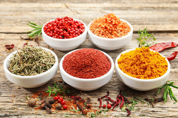 Different aromatic spices on wooden table, closeup