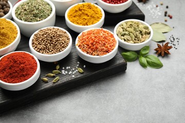 Different aromatic spices on grey table, closeup. Space for text