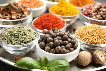 Different aromatic spices in bowls on table, closeup