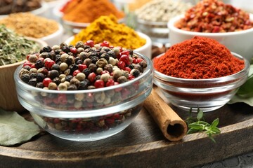 Different aromatic spices in bowls on table, closeup