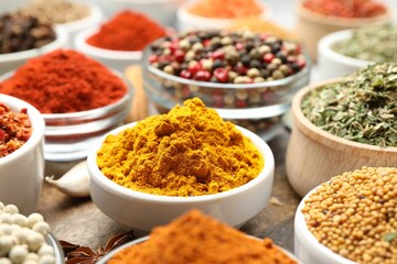Different aromatic spices in bowls on table, closeup