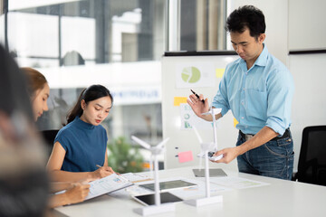 Sustainability and ESG. Team discussing renewable energy solutions in a modern office.