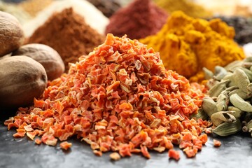 Many different spices on dark table, closeup