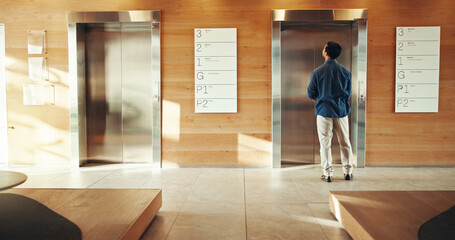 Business, man and waiting at elevator in building for floor request, meeting appointment and destination. Back, professional person and office lift for work arrival, departure and morning routine © CC2000/peopleimages.com